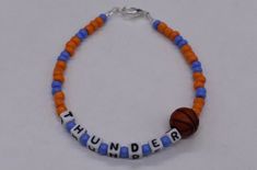 .  Oklahoma City Thunder Basketball Bracelet, Thunder Bracelet, Sports Bracelet, Sports Jewelry Thunder bracelet Is made with Blue and Orange seeds beads, white plastic letters, beading wire, 1 basketball bead, and a lobster clasp. There are so many Varieties out there so if you need something special let me know. Thanks for your business! Please don't forget to like my shop. Once I mail off the package with usps, I have no control over the package once it's in there hands, therefore I will NOT Blue Sporty Bracelet For Sports, Sporty Blue Bracelet For Sports, Sporty Blue Bracelets For Sports Events, Basketball Bracelet, Bracelet Business, Team Bracelets, Thunder Basketball, Plastic Letters, Okc Thunder