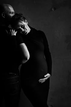 black and white photograph of a pregnant couple