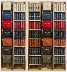 two wooden shelves filled with books on top of each other