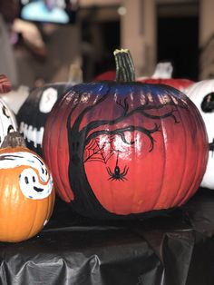 three pumpkins with faces painted on them