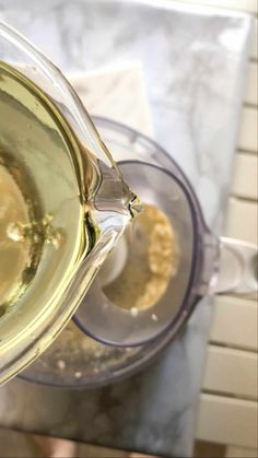 a pitcher filled with liquid sitting on top of a counter