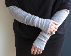 a woman with her arm wrapped in a sweater