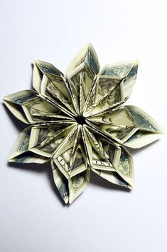 dollar bill origami snowflake on white background