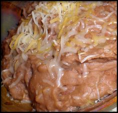 a close up view of some food with cheese and sauce on it's surface