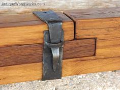 a close up of a piece of wood with a metal latch on the outside of it