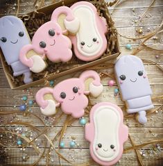 decorated cookies in the shape of animals on a wooden table next to some candy canes