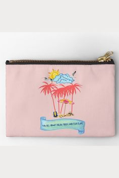 a pink pouch bag with palm trees and clouds on the top, in front of a white background