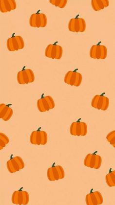 an orange background with small pumpkins on it