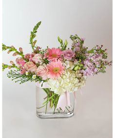 a vase filled with lots of pink and white flowers