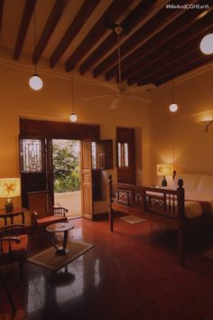 a room with two beds and lamps on the ceiling