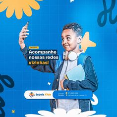 a man holding a cell phone in front of a blue and yellow background with flowers