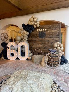 the entrance to a birthday party with balloons and letters that spell it's 60