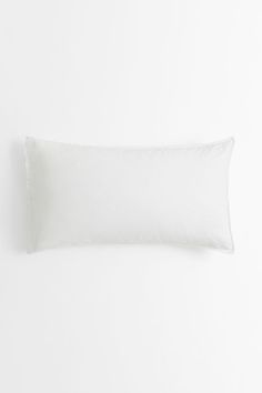 a white pillow on a white wall