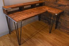 a wooden desk with hairpin legs in front of a wall