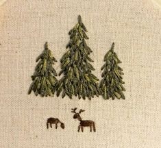 an embroidery project with trees and animals on it