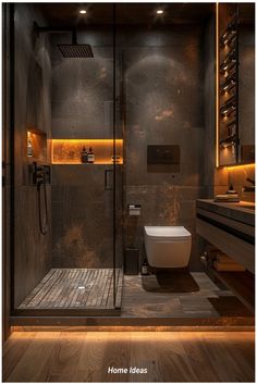 a bathroom with a toilet, sink and shower in it's stall area at night