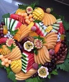 a platter filled with lots of different types of fruits and veggies on top of each other