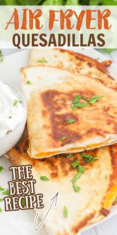 grilled quesadillas on a white plate with sour cream and cilantro