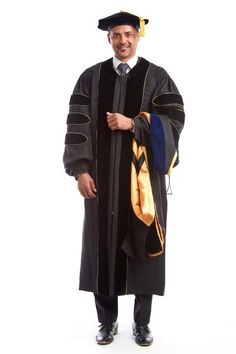 a man in a graduation gown and cap is posing for the camera with his arms crossed