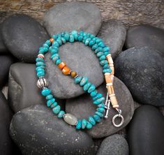 This Native American Spiny Oyster, Turquoise, Quartz, Tiger Eye and silver bead necklace is that signature necklace that you've been searching for. It is handcrafted into a beautiful array of color. This is one of a kind and made just for you! Perfect for dressing up a tee shirt and jeans wardrobe! 18 7/8" Cannot be adjusted Weight: 36 grams Unique Hand-strung Turquoise Beaded Necklace, Handmade Turquoise Amazonite Necklace, Artisan Amazonite Round Bead Necklace, Artisan Turquoise Beaded Necklaces With Natural Stones, Artisan Turquoise Necklace With Round Beads, Artisan Single Strand Turquoise Necklace For Jewelry Making, Artisan Turquoise Necklace For Jewelry Making, Artisan Turquoise Amazonite Necklace, Handmade Artisan Amazonite Necklace