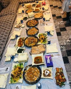 a long table with many plates of food on it