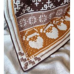 a crocheted afghan with santa claus on it's face and beards