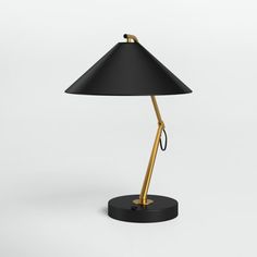 a black and gold lamp on a white background