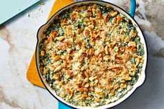 a casserole dish with chicken and spinach in it on a blue plate