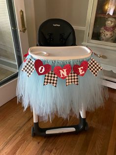 a baby's highchair with a one in the middle banner on it