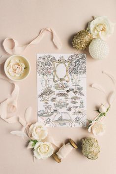 the wedding stationery is surrounded by flowers, candles and other things to put on it