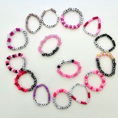 You will receive 15 random bracelets of my choice, each featuring unique song titles, including a few dedicated to P!nk. If you have a particular song title in mind, or want a special phrase, just leave a note during checkout or send a message, and I will make it happen for you! Bracelets are made with plastic beads, plastic letter beads, glow beads, clay beads, jewelry glue, and 0.8mm elastic stretch cord. Sizing will vary between 7.0 inches to 8.5 inches.  Packages will ship within 1-2 business days after the date of purchase.  These are not a toy and not intended for small children. No returns or exchanges accepted. P!nk Bracelets, Customizable Pink Name Bracelet For Everyday, Playful Pink Bracelets With Custom Name, Customizable Playful Pink Friendship Bracelets, Pink Fun Style Name Bracelet For Birthday, Pink Fun Name Bracelet For Birthday, Playful Customizable Pink Friendship Bracelets, Customized Pink Novelty Jewelry, Customizable Novelty Pink Jewelry