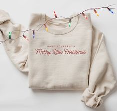 Festive minimalist EMBROIDERED Merry Christmas Sweatshirt. I have this sweatshirt with red embroidery as well: https://studioesmerose.etsy.com/listing/1558740458 A sturdy and warm sweatshirt bound to keep you warm in the colder months. A pre-shrunk, classic fit sweater that's made with air-jet spun yarn for a soft feel and reduced pilling. * 50% cotton, 50% polyester * Pre-shrunk * Classic fit * 1x1 athletic rib knit collar with spandex * Air-jet spun yarn with a soft feel and reduced pilling * Double-needle stitched collar, shoulders, armholes, cuffs, and hem This product is made especially for you as soon as you place an order, which is why it takes us a bit longer to deliver it to you. Making products on demand instead of in bulk helps reduce overproduction, so thank you for making thou Christmas Sweather, Christmas Sweatshirt Ideas, Hoodie Trend, Hoodies For Girls, Christmas Sales, Merry And Bright Christmas, Christmas Apparel, Girls Hoodie, Minimal Christmas