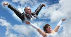 a bride and groom are flying through the air