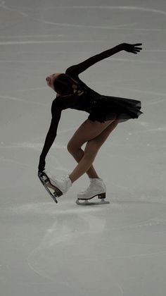 a female figure skating on an ice rink