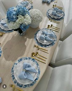 a table set with blue and white flowers