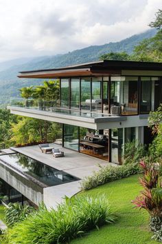 a modern house overlooking a lush green hillside