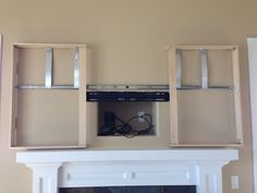 a fire place in a living room with shelves above it