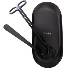 a pair of scissors sitting on top of a black case next to it's opener