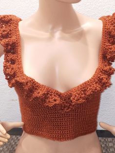 a mannequin wearing an orange top with ruffles