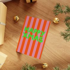 a christmas card with the words happy xmas on it next to presents and wrapped gifts