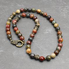 "* Made with Red Creek Jasper 8mm round beads, which has the earthy multi-colors of tan, olive green, burnt red, charcoal gray, and more. The softly muted colors of this natural stone makes it great for both men and women. * Embellished with antiqued brass finish pewter beads and brass spacers. It closes with an unique looking lobster clasp in antiqued brass finish pewter. * Strung with a professional quality durable wire, which is made of 49-strand fine stainless steel bundled and nylon coated. Bead Necklace For Men, Red Creek Jasper, Earthy Jewelry, Dope Jewelry, Natural Stone Jewelry, Vert Olive, Funky Jewelry, Jewelry Lookbook, Bohemian Necklace