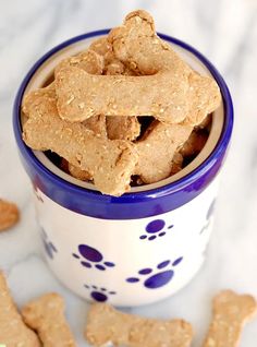 a blue and white bowl filled with dog treats