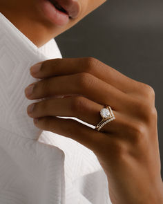 a woman's hand wearing a diamond ring