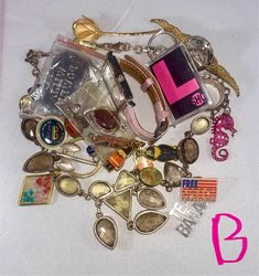 This is a lot of bunch of different jewelry and parts, mismatched pieces, broken earrings and necklaces, lots of pendants, rings, watch parts, hair ornaments, bracelets, pins and brooches that would work great for an assemblage or art piece or jewelry making.  I have been collecting these jewelry pieces for years and I am moving so I'd like these to go to aspiring artisans. Each lot contains just over 8oz of the jewelry as pictured and will be shipped to you right away! Please indicate the letter of the lot you'd like and I will update and indicate those that have sold. Have fun and create! Eclectic Gold Jewelry For Jewelry Making, Eclectic Gold Jewelry Gift, Unique Party Jewelry With Charms, Multicolor Metal Jewelry With Vintage Charm, Vintage Pink Charm Jewelry, Eclectic Nickel-free Jewelry For Gifts, Vintage Pink Jewelry With Charms, Artsy Gold Pendant Jewelry, Pink Vintage Jewelry With Charms