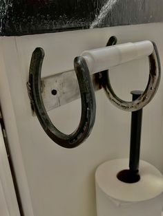 a toilet paper holder with two rings attached to it