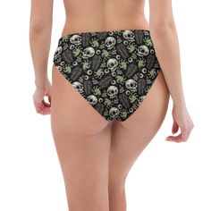 Step into chilling summer style with Goth Cloth Co.'s Gothic Zombie Bikini Bottom. Featuring a spooky pattern of skulls, coffins, zombie hands, and eyeballs, these bottoms blend gothic elegance and apocalyptic flair, making them ideal for all your beach and poolside escapades. Key Features: Recycled polyester fabric: Made from 88% recycled polyester and 12% elastane in the EU, or 81% REPREVE recycled polyester and 19% LYCRA XTRALIFE in MX, providing a soft, stretchy fit. Double-layered design: Offering secure comfort for various body types. Zig-zag stitching: For added style and longevity. Tear-away care label: Making it easy to remove tags. Mix-and-match versatility: Pair with different bikini tops for a variety of looks. UPF 50+: Maximum sun protective rating achievable for fabrics. Thes Black Rave Bottoms For Beach, Gothic Fitted Bottoms With Skull Print, Fitted Gothic Bottoms With Skull Print, Fitted Halloween Bottoms With Skull Print, Spooky Pattern, Zombie Hands, Dark Summer, Gothic Elegance, Zombie Hand