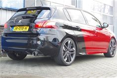 the rear end of a red and black car