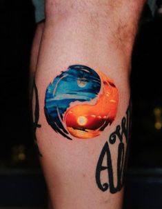 a man with a tattoo on his leg that has an orange and blue yin yang symbol