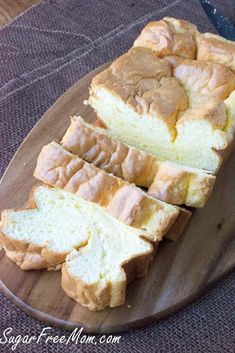 sliced loaf of bread sitting on top of a wooden plate