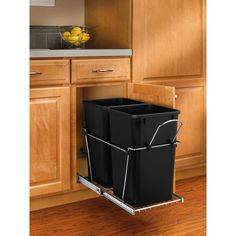 two black trash cans sitting on top of a kitchen cabinet